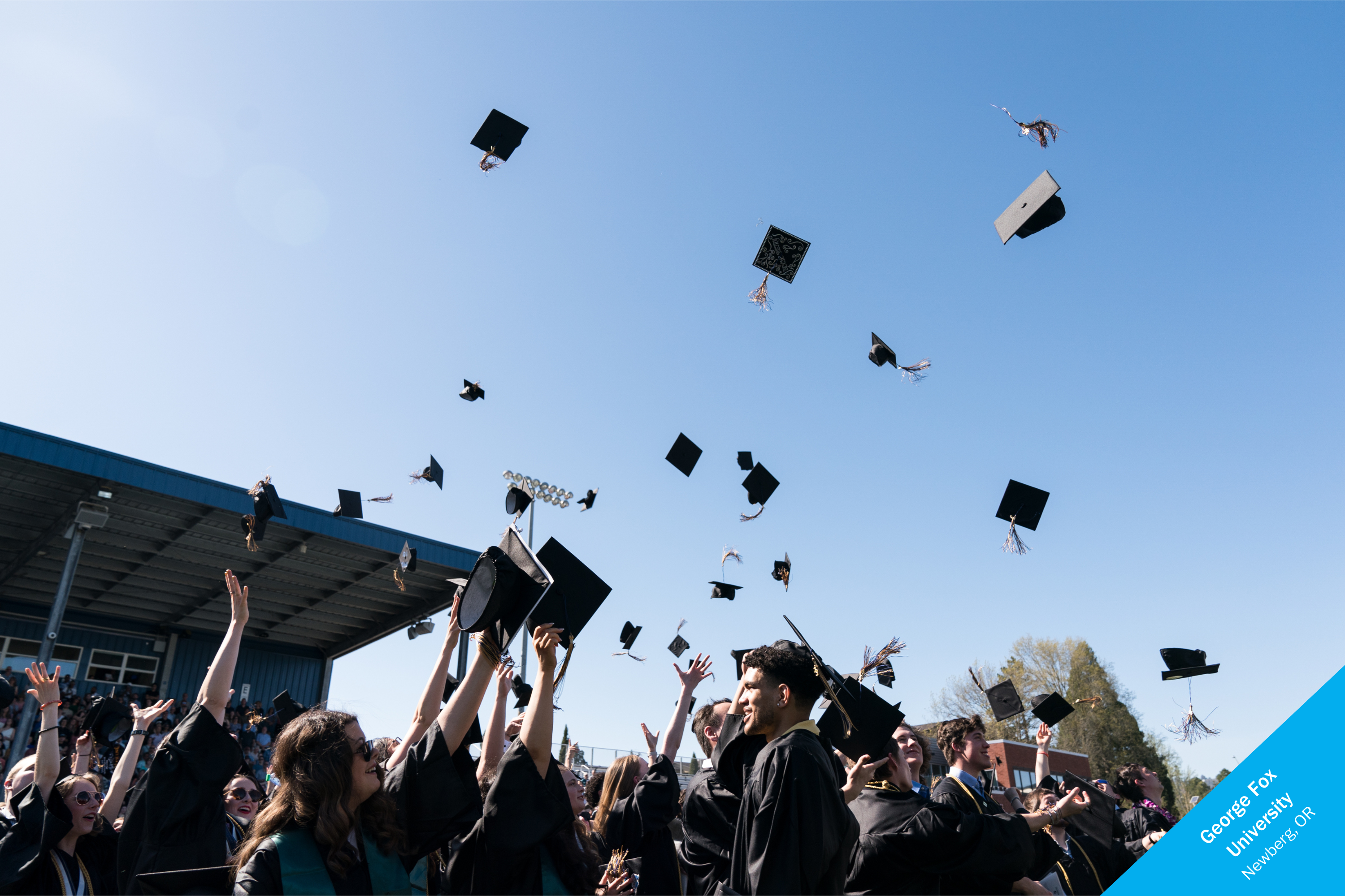 Students throwing their graduation caps in the air.