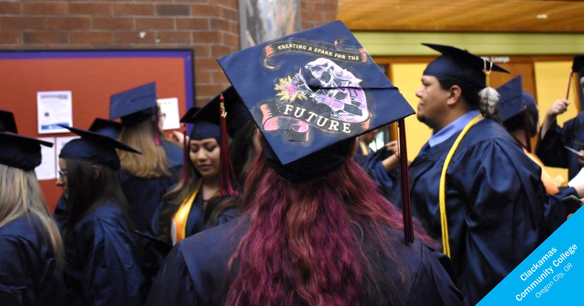 Women's graduation cap decorated with image of welder from Clackamas Community College