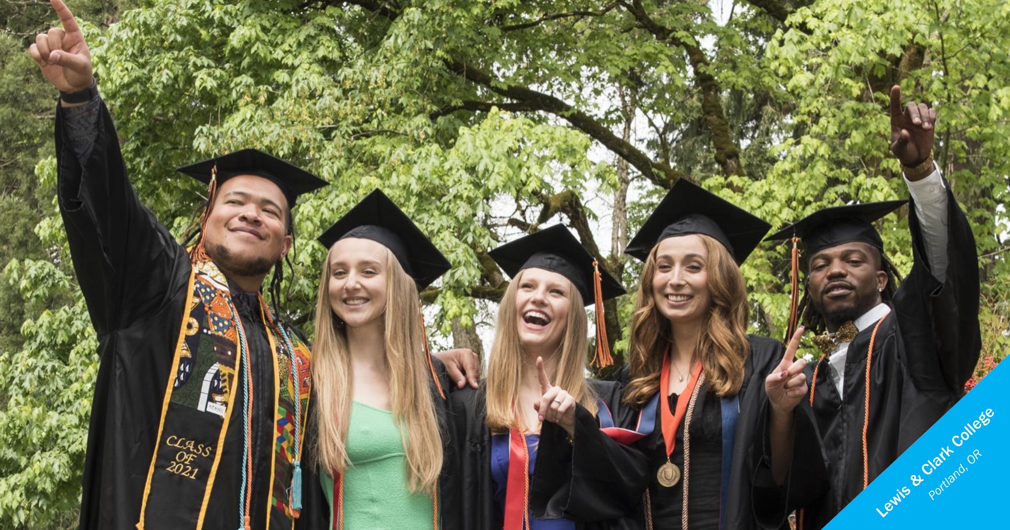 Lewis & Clark College graduates smiling and pointing