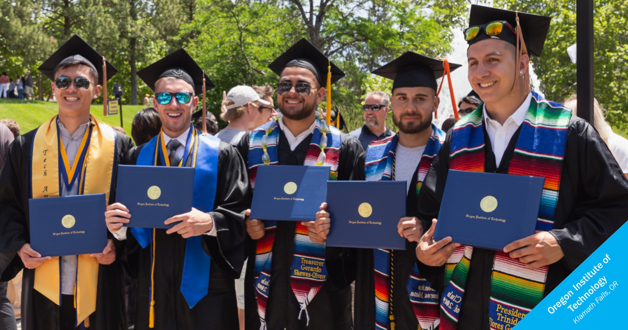 Smiling Latino graduates of Oregon Institute of Technology