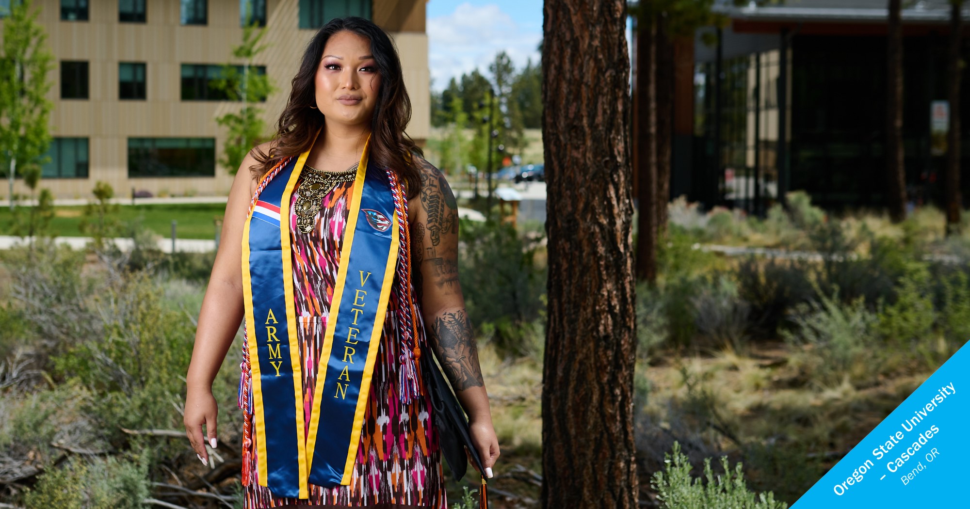 Woman of color posing with graduation hat and veterans stole from OSU Cascades