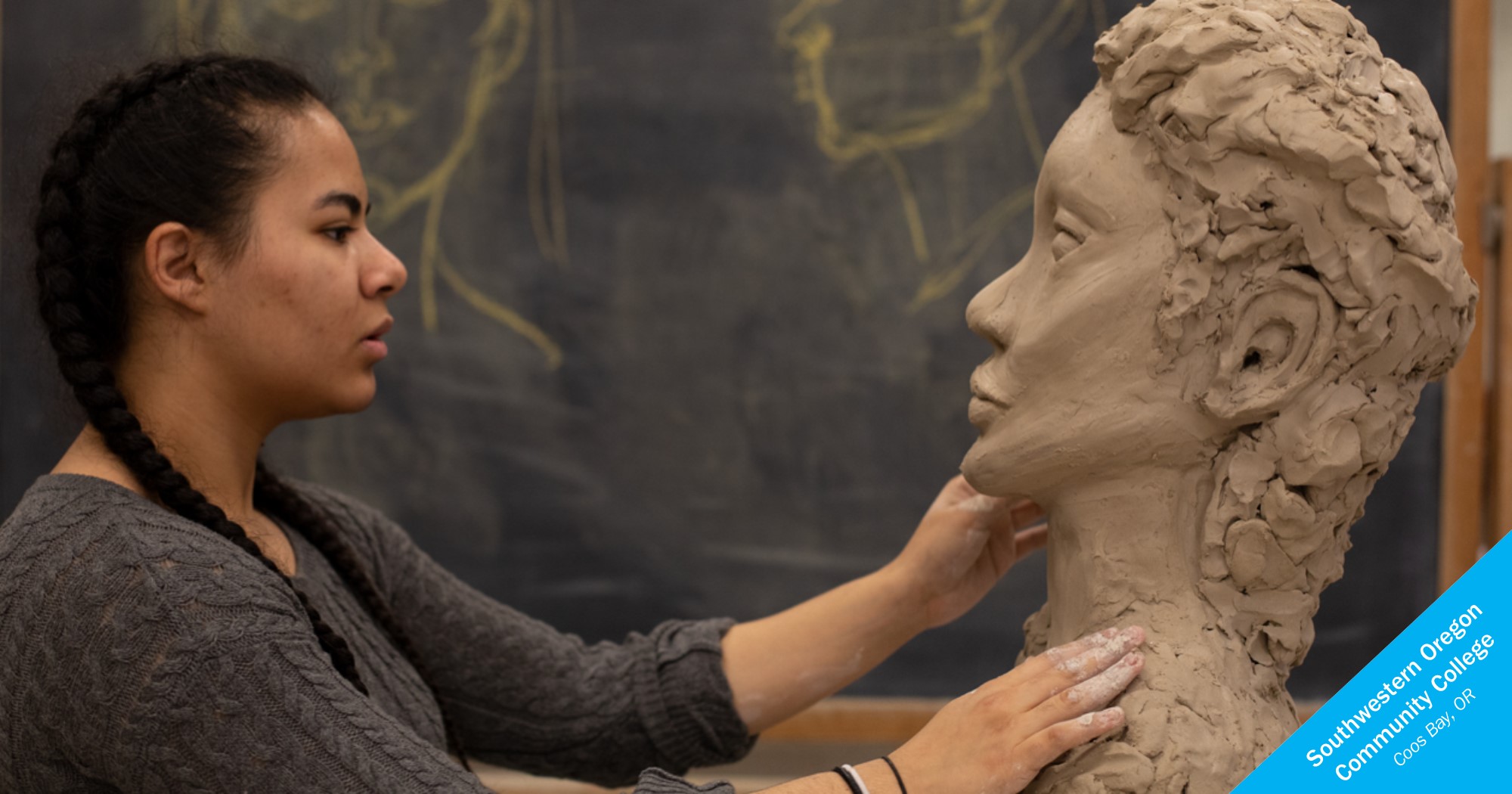 Woman of color sculpting a head at Southwestern Oregon Community College