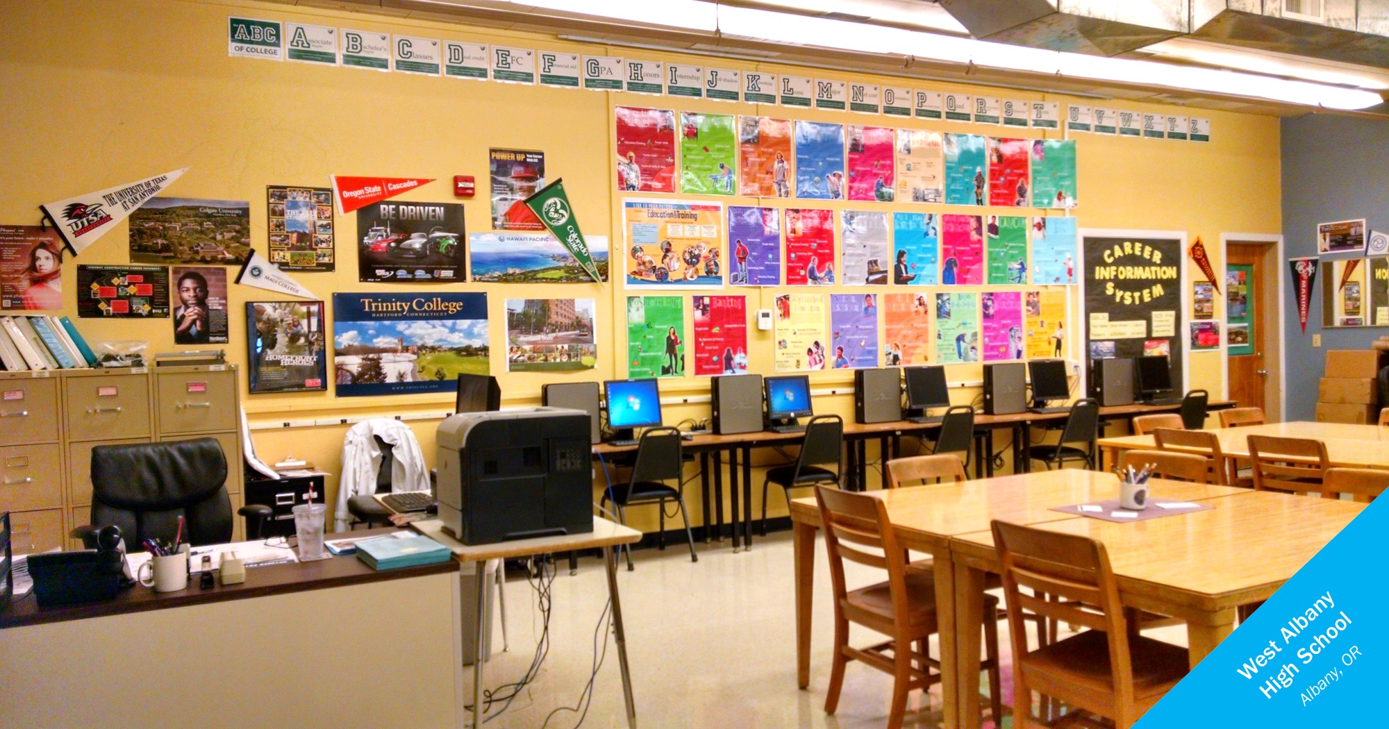Painted room with college posters and computers at West Albany High School